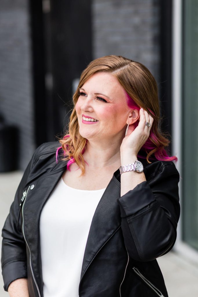 Pamela, a Canadian tech strategist and VIP Day expert, smiling confidently in a leather jacket.
